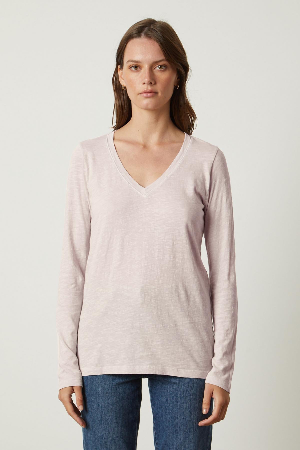 A woman wearing a Velvet by Graham & Spencer BLAIRE ORIGINAL SLUB TEE in whisper-soft cotton pink v-neck.-36118387097793