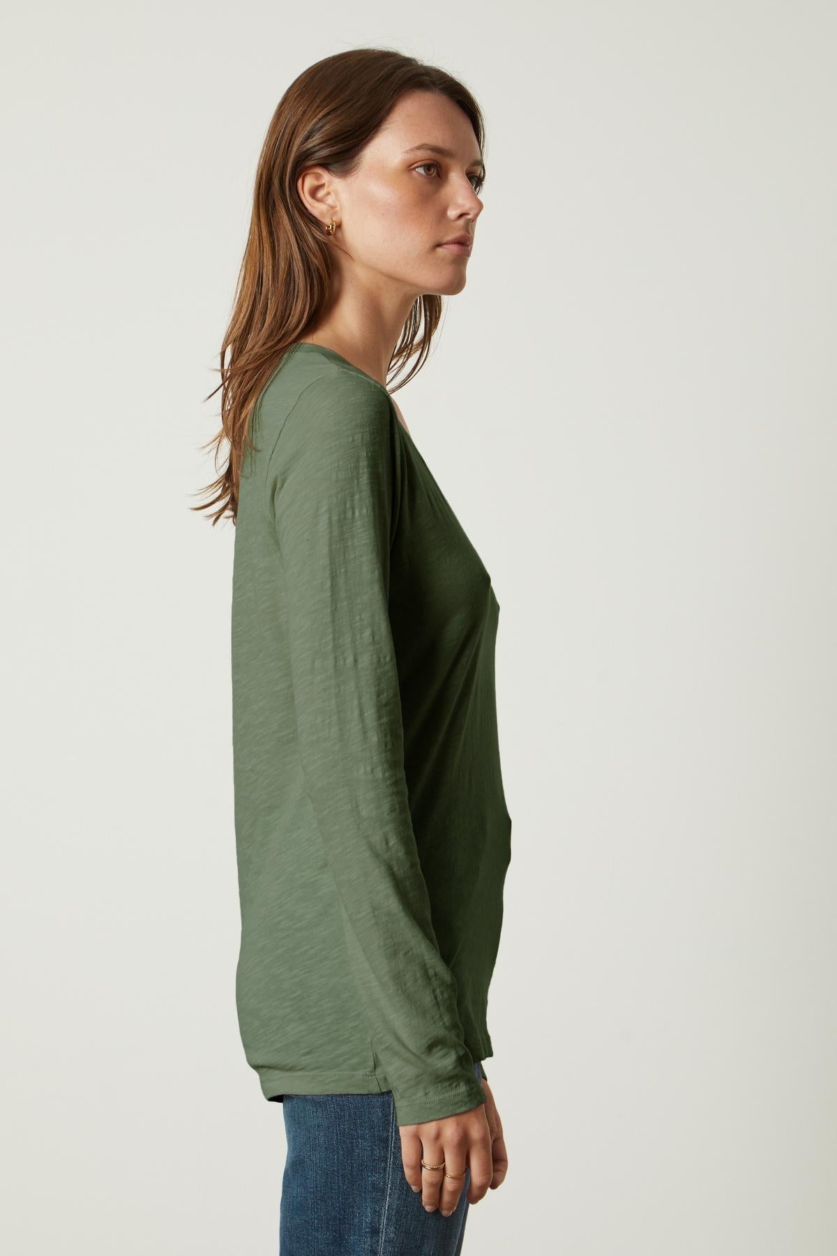 The back view of a person wearing jeans and a Velvet by Graham & Spencer BLAIRE ORIGINAL SLUB TEE.-35782759186625