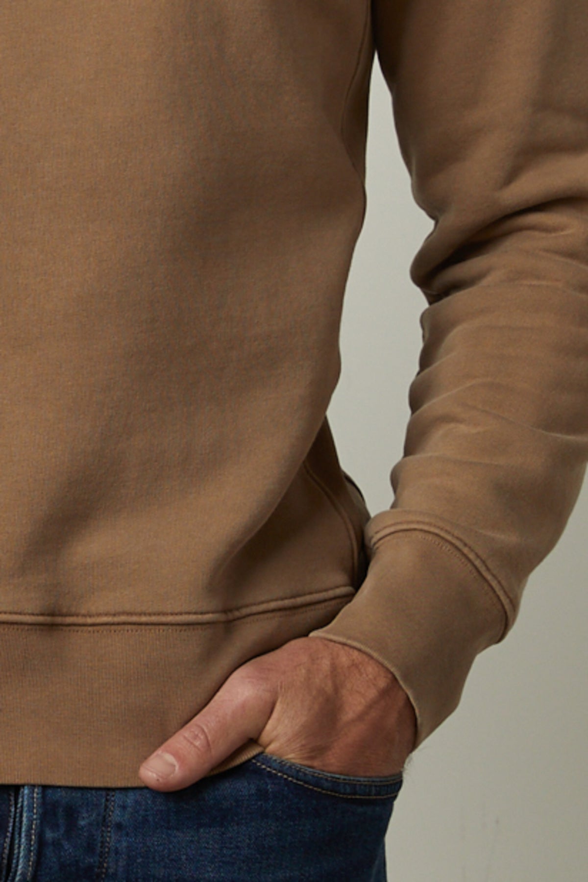 A man wearing a Velvet by Graham & Spencer MATTS CREW NECK SWEATSHIRT and jeans, providing comfort and warmth.-35783000031425