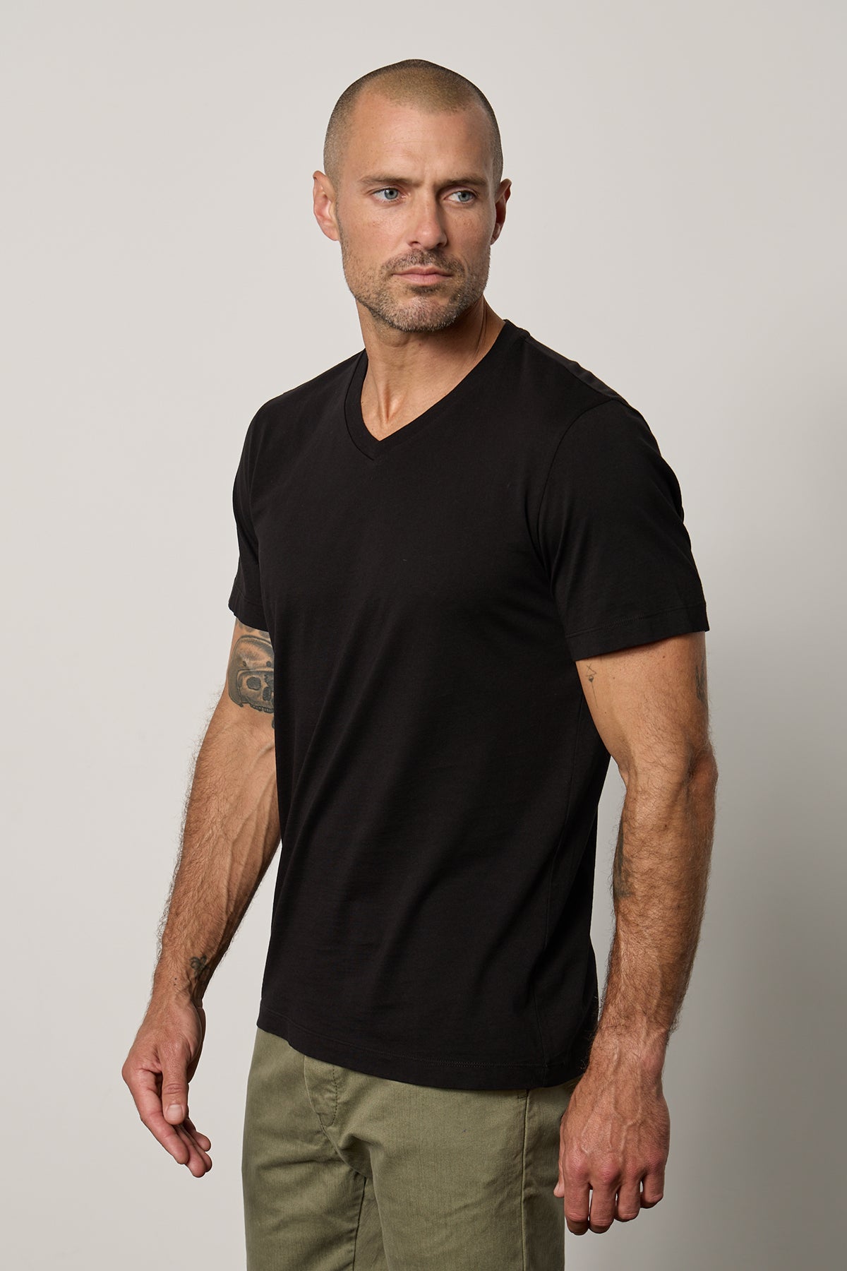 a man wearing a black Velvet by Graham & Spencer MARSHALL V-NECK TEE.