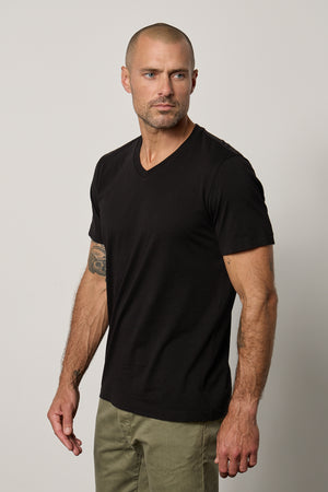 a man wearing a black Velvet by Graham & Spencer MARSHALL V-NECK TEE.