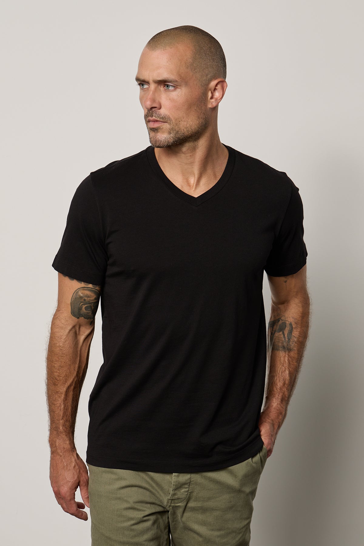 a man wearing a black Velvet by Graham & Spencer MARSHALL V-NECK TEE.