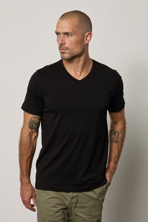a man wearing a black Velvet by Graham & Spencer MARSHALL V-NECK TEE.