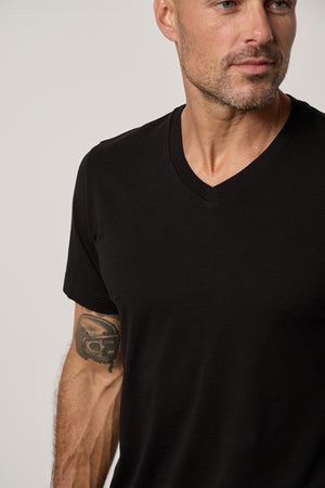 a man wearing a black Velvet by Graham & Spencer MARSHALL V-NECK TEE.