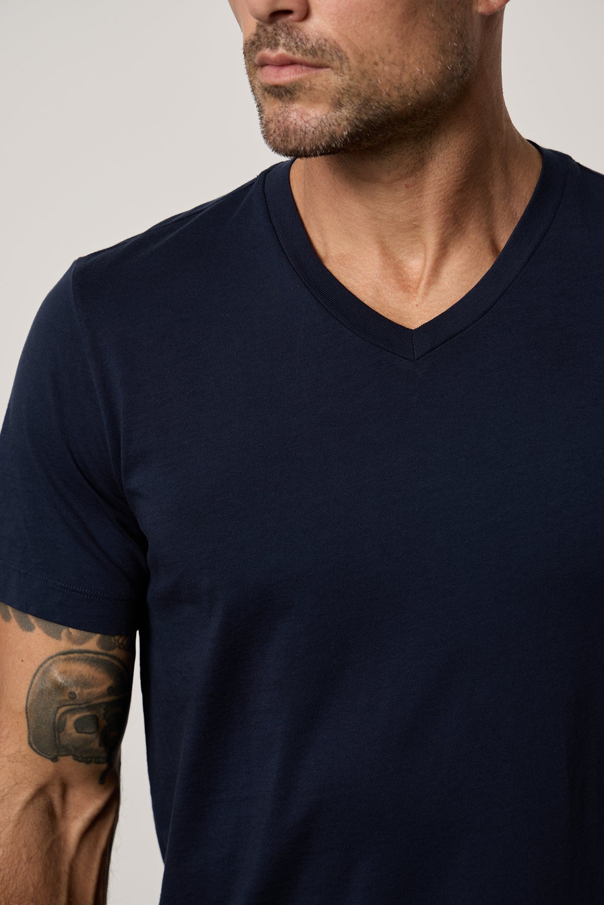a man wearing a navy Velvet by Graham & Spencer MARSHALL V-NECK TEE.