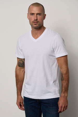 a man wearing a white Velvet by Graham & Spencer MARSHALL V-NECK TEE.