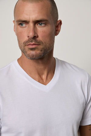 a man wearing a white Velvet by Graham & Spencer MARSHALL V-NECK TEE.