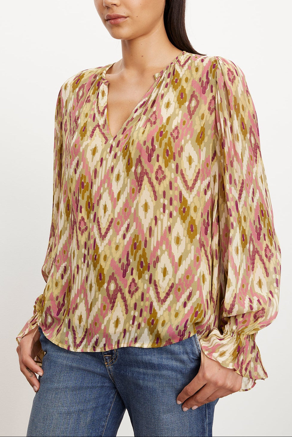 A model wearing the Kathy Printed V-Neck Blouse by Velvet by Graham & Spencer, showcasing femininity, made of printed viscose georgette.-35577841221825
