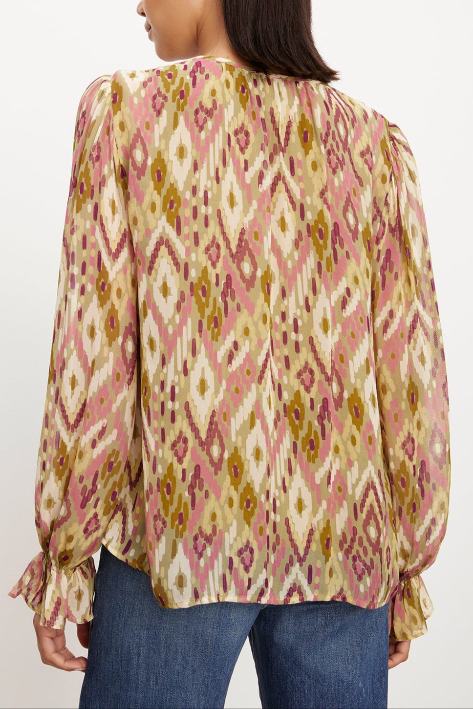The view reveals the femininity of a woman adorned in a Velvet by Graham & Spencer Kathy Printed V-Neck Blouse.