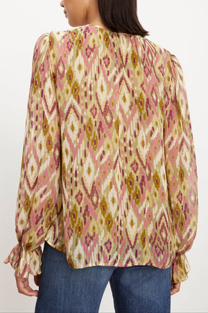 The view reveals the femininity of a woman adorned in a Velvet by Graham & Spencer Kathy Printed V-Neck Blouse.