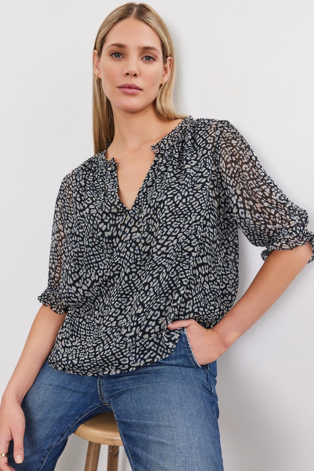 The model is wearing the Velvet by Graham & Spencer MISSY PRINTED BOHO BLOUSE.-35624748122305