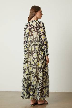 The back view of a woman wearing a Velvet by Graham & Spencer Serena Printed Maxi Dress.