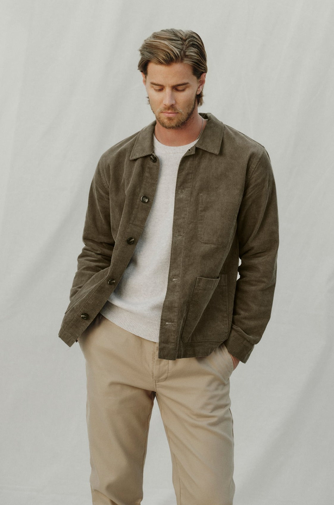 A man wearing a REIKO CORDUROY CHORE JACKET by Velvet by Graham & Spencer with front patch pockets.-35179727487169