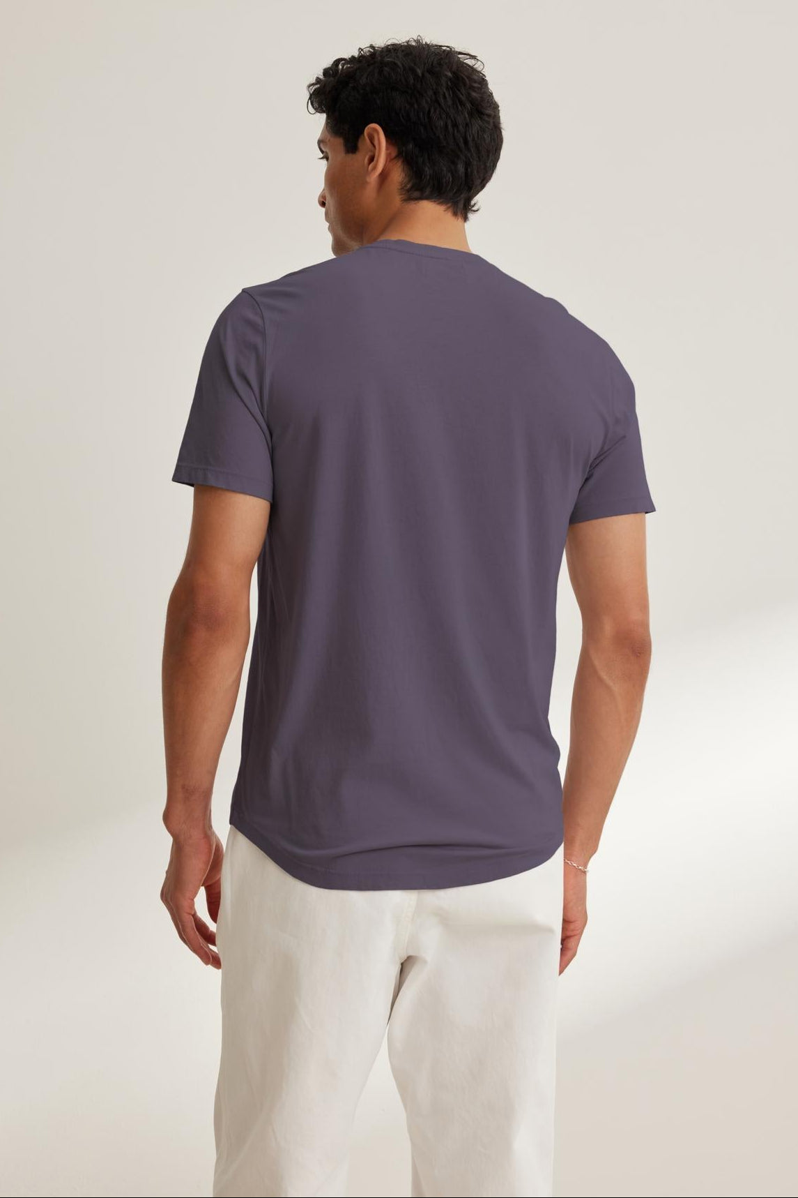 An individual in a gray FULTON HENLEY by Velvet by Graham & Spencer and white pants is standing with their back to the camera against a plain background.-38658659549377