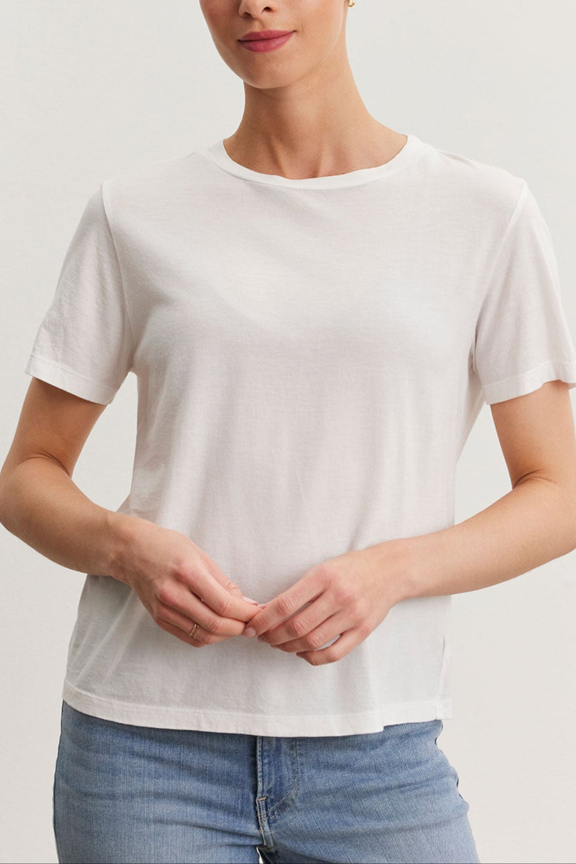 Woman in a Velvet by Graham & Spencer Ryan Tee and blue jeans standing against a plain background.