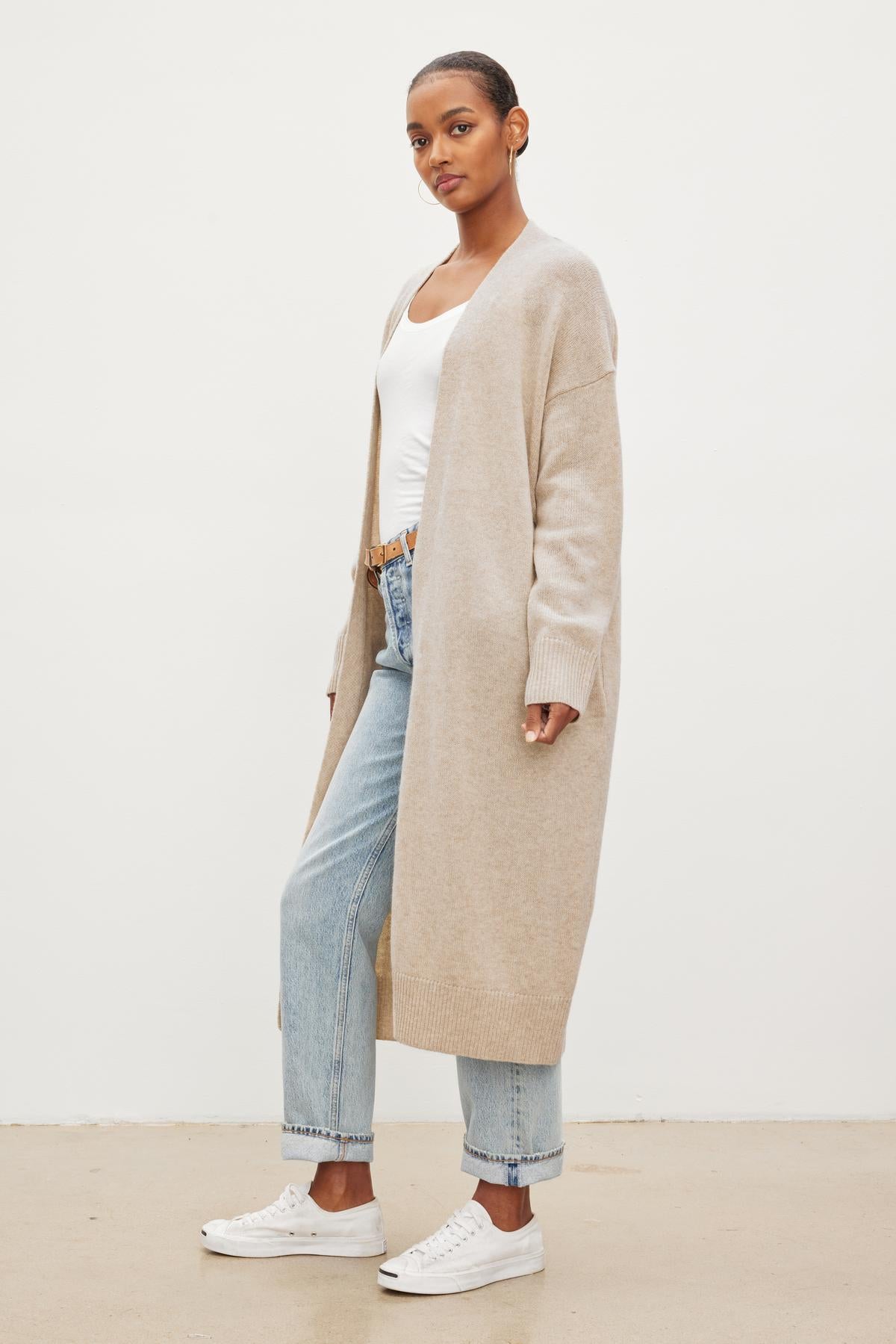 The model is wearing a Velvet by Graham & Spencer LISA WOOL CASHMERE DUSTER CARDIGAN and jeans.-26921634693313