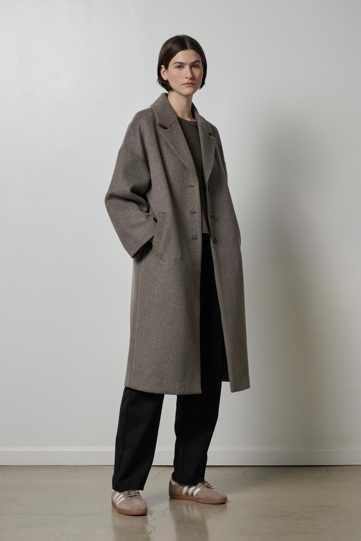 A woman wearing a classic Huntington coat by Velvet by Jenny Graham.-35200231735489
