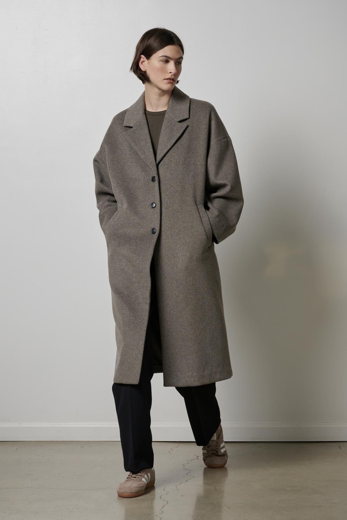 A woman wearing an oversized Huntington coat by Velvet by Jenny Graham.-35200231833793