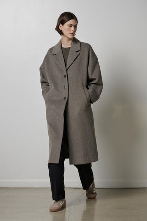 A woman wearing an oversized Huntington coat by Velvet by Jenny Graham.