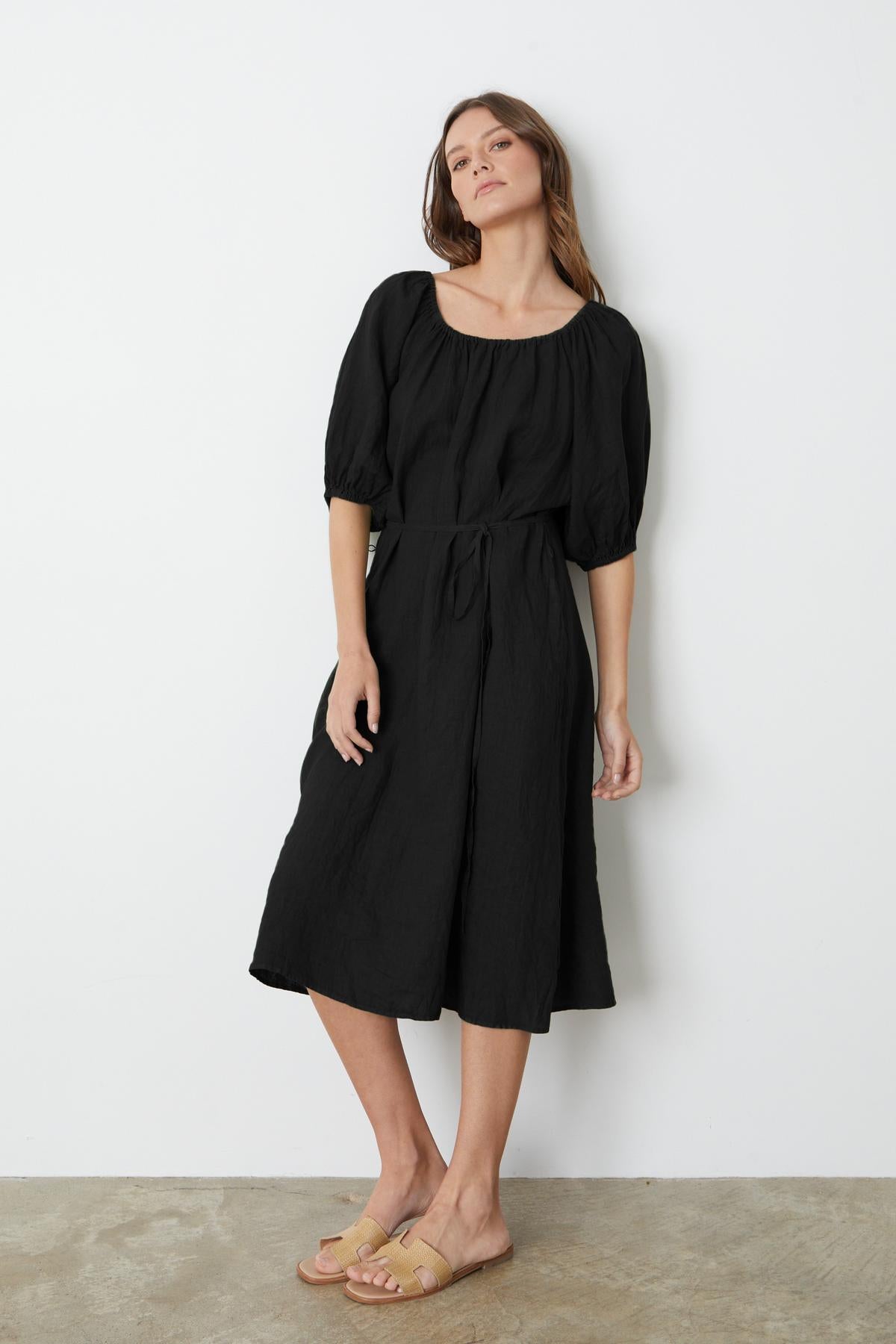 A person wearing a Velvet by Graham & Spencer Elly Linen Midi Dress and sandals.