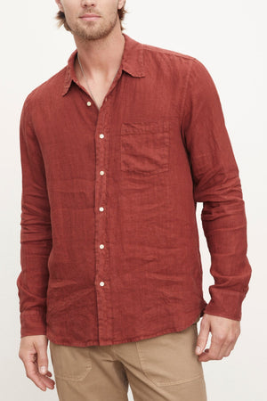 A stylish man wearing a Velvet by Graham & Spencer men's BENTON LINEN BUTTON-UP SHIRT.