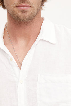 A stylish man wearing a Velvet by Graham & Spencer BENTON LINEN BUTTON-UP SHIRT.