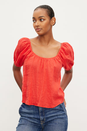 The model is wearing a Velvet by Graham & Spencer DANA LINEN SCOOP NECK TOP with puff sleeves.
