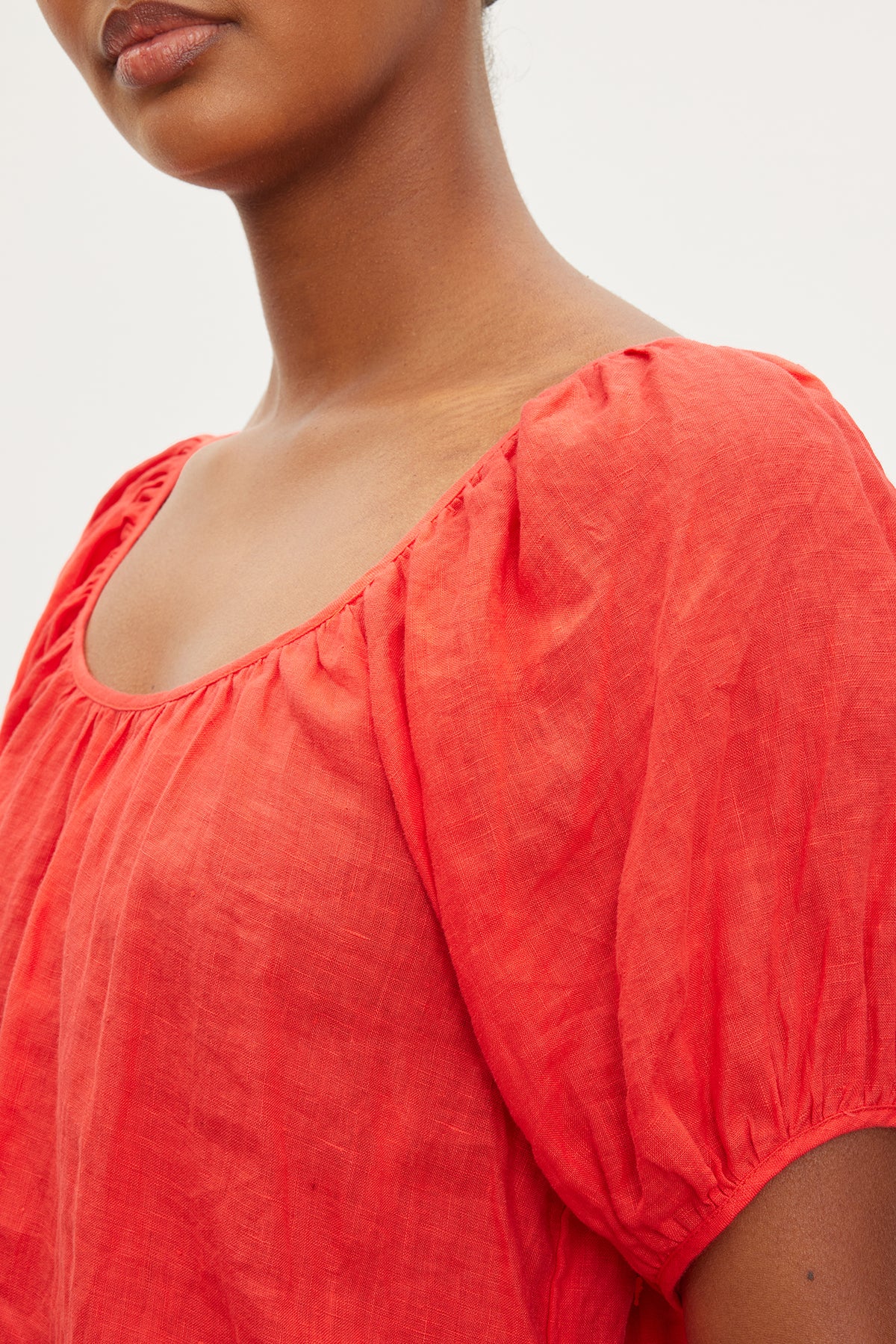 A woman wearing a Velvet by Graham & Spencer Dana Linen Scoop Neck Top with a puff sleeve.-35955692372161