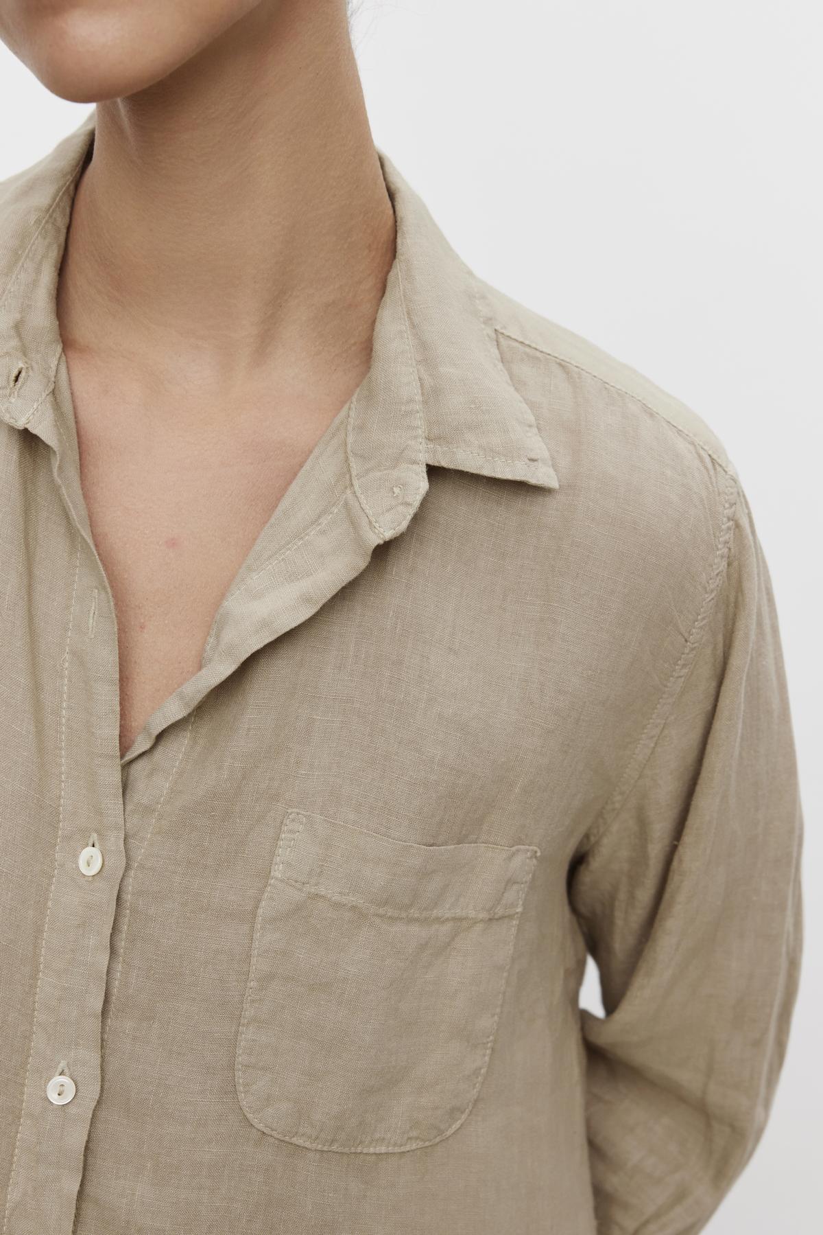 Close-up of a person wearing a Velvet by Jenny Graham Mulholland shirt with a relaxed silhouette, a collar, and chest pocket.