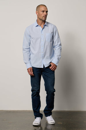 Brooks Button-Up Shirt in mist blue with dark blue denim and white Converse full length front