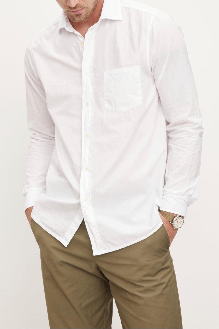 A man wearing a Velvet by Graham & Spencer BROOKS BUTTON-UP SHIRT and traditional trousers.