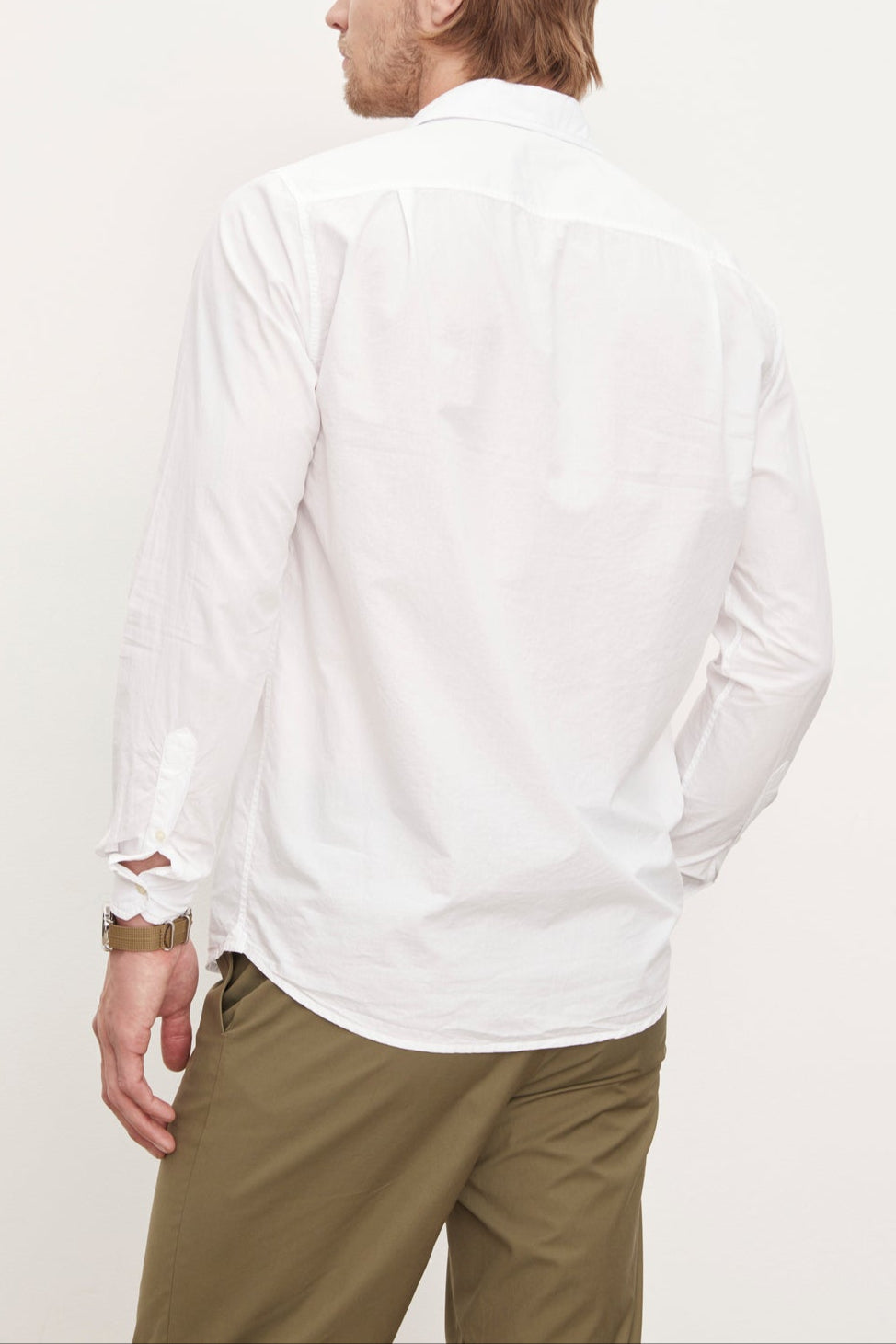 The back of a man wearing a Velvet by Graham & Spencer BROOKS BUTTON-UP SHIRT and traditional khaki pants from his wardrobe.