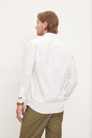The back of a man wearing a Velvet by Graham & Spencer BROOKS BUTTON-UP SHIRT and traditional khaki pants from his wardrobe.