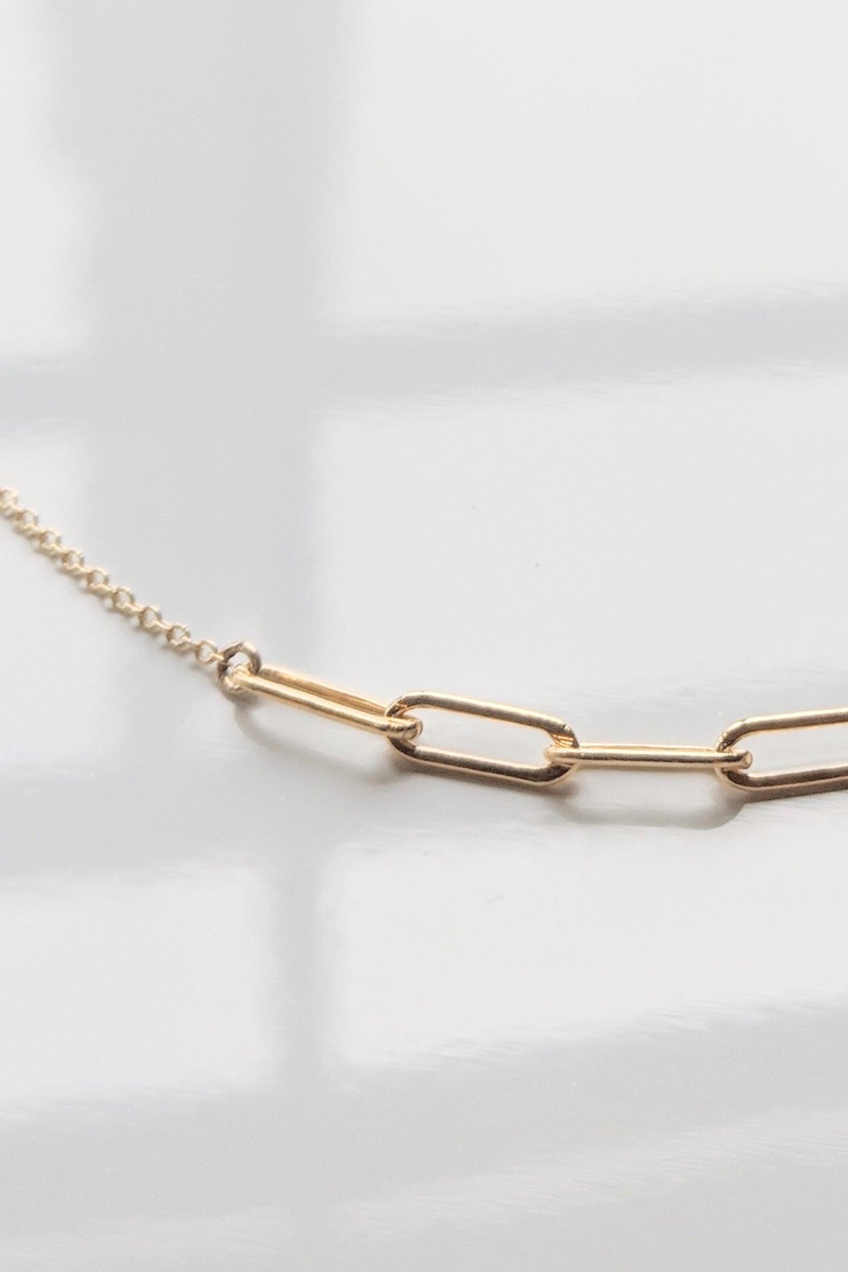 A Cora Necklace by Thatch, an everyday piece in a jewelry collection, on a white surface.