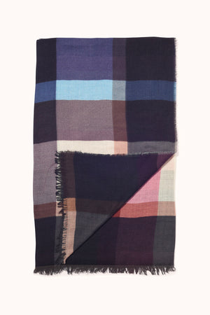 The PLAID WOOL BLEND SCARF BY EPICE features a large plaid pattern in blue, pink, purple, and beige. Made from a soft wool blend by Epice, it has fringed edges and a stylishly folded corner for an elegant touch.