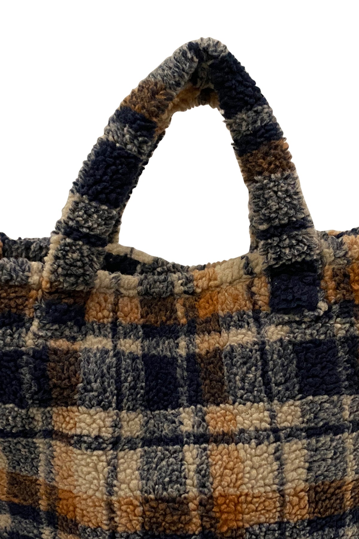A close-up image of a handle on a SMALL TEDDY TOTE by Velvet by Graham & Spencer, a plaid-patterned, faux shearling tote bag made of textured, fluffy material. The cold-weather plaid design features shades of blue, orange, and beige.-25426501009601