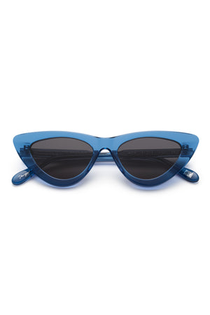 006 BY CHIMI EYEWEAR by Chimi—blue cat-eye sunglasses with dark tinted lenses, shown front-facing on a white background. Trendy unisex shades from a top eyewear brand.