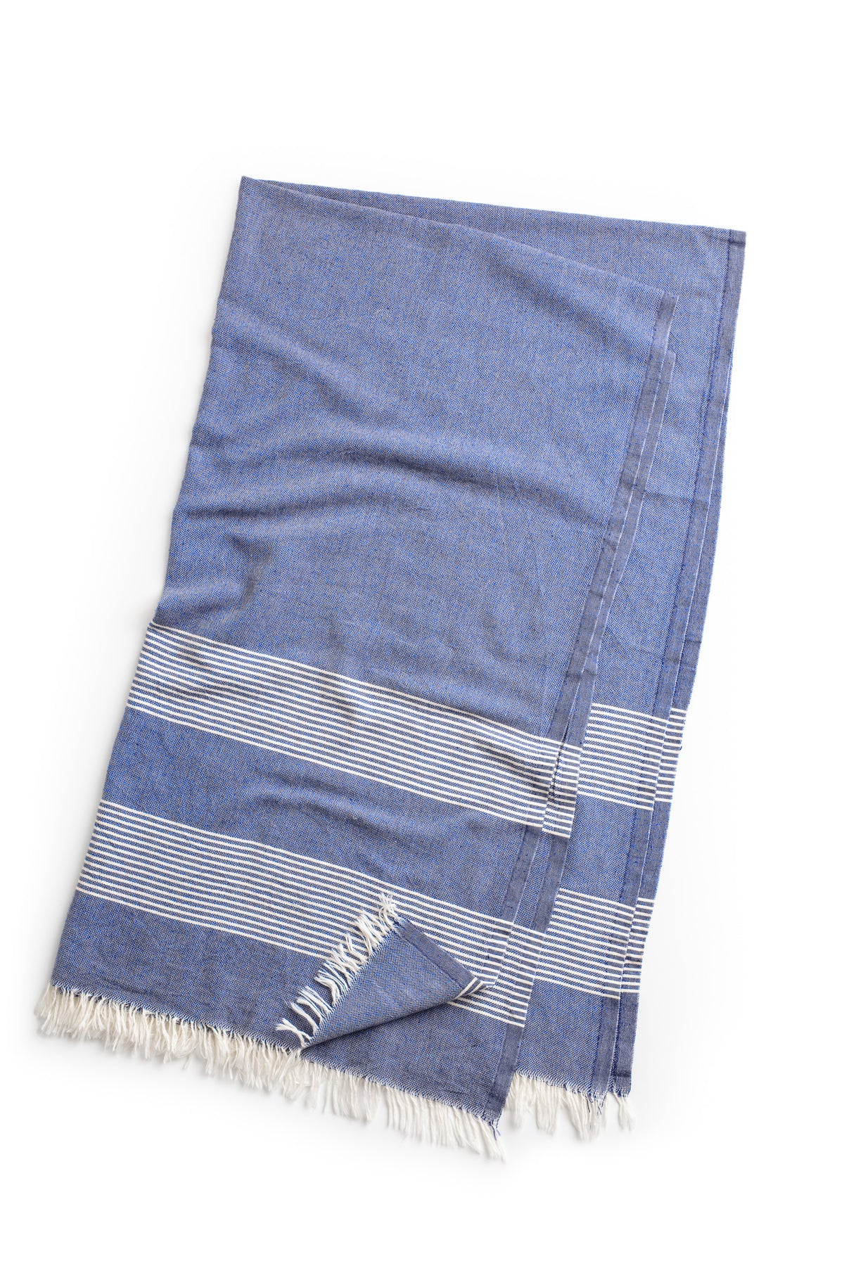 a blue and white striped BEACH THROW by Velvet by Graham & Spencer on a white background.