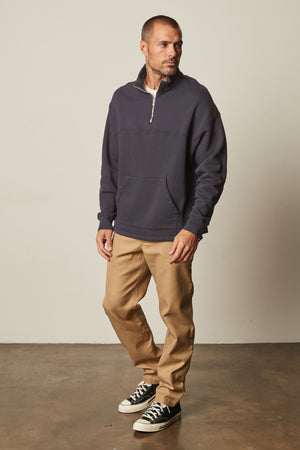 Baldwin Quarter-Zip Sweatshirt in blue ink front with khaki Aiden pants and Converse full length front