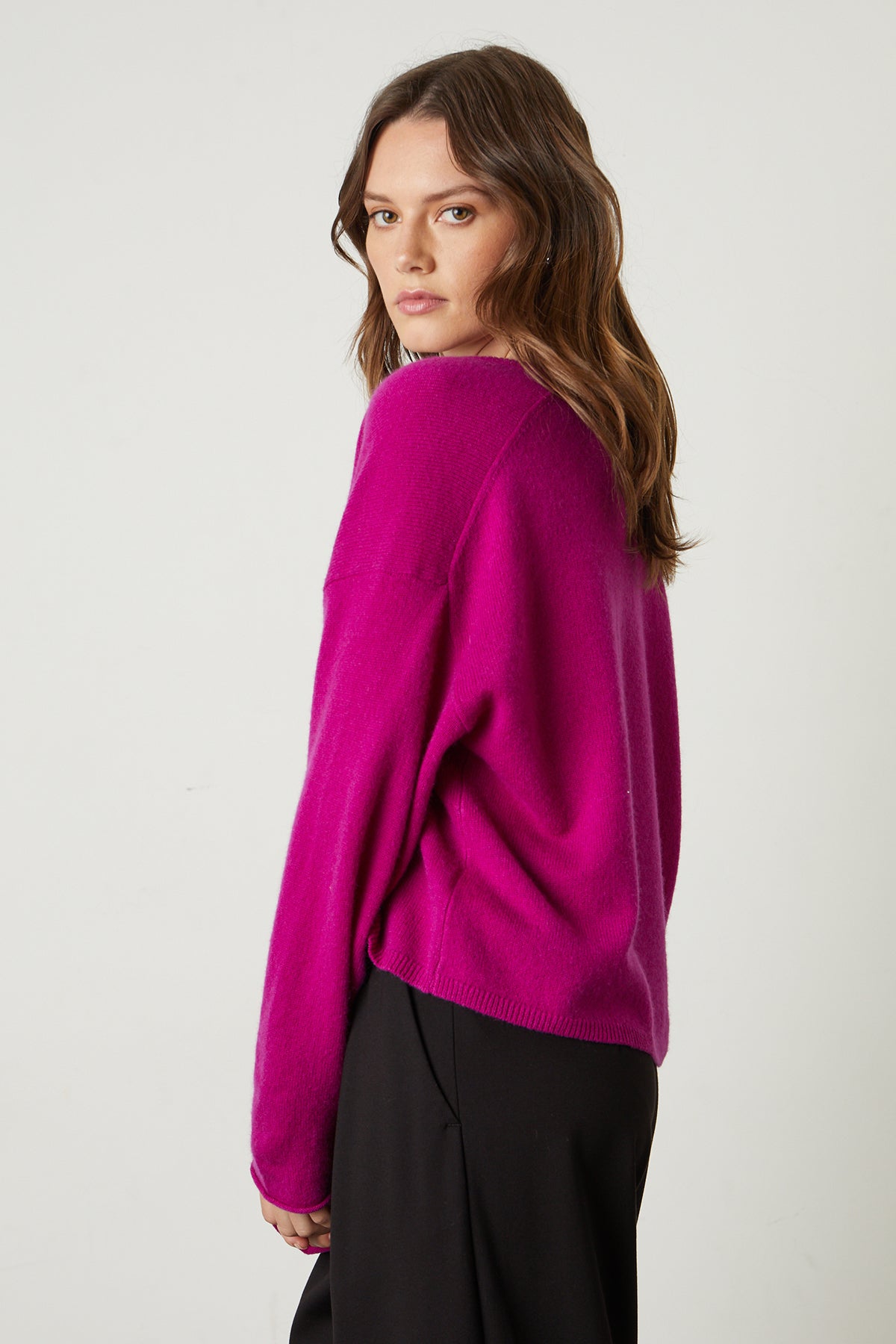 Amika Cashmere V-Neck Sweater in bright magenta pink with Leona pant side