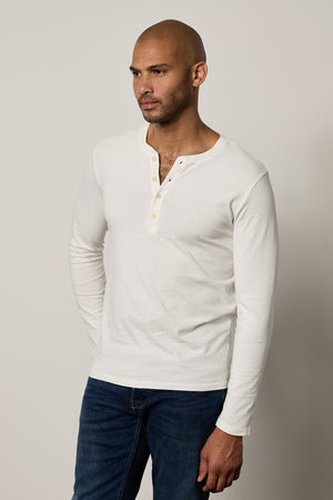 a man wearing jeans and a Velvet by Graham & Spencer BRAD HENLEY t-shirt.