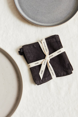 a set of LINEN COASTERS (SET OF 4) on a white surface, brand name Jenny Graham Home.