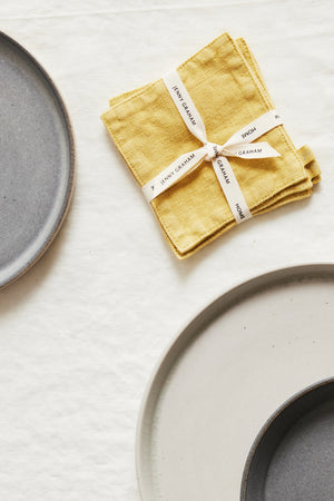 A set of Jenny Graham Home linen coasters (set of 4) on a white surface.
