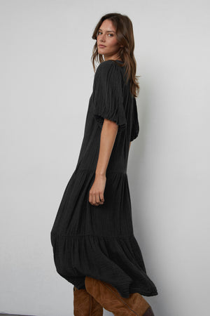 Pauline Cotton Gauze Midi Dress in Black side view with brown boots