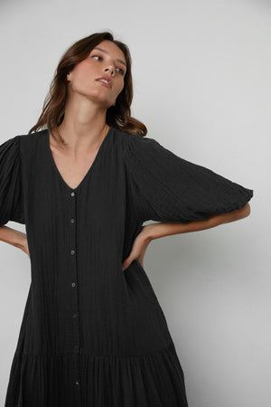 Model Standing with Hands on Hips wearing Pauline Cotton Gauze Midi Dress in Black Front Close up