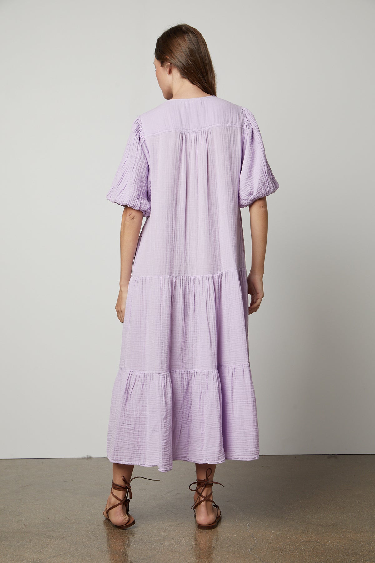 The back view of a woman wearing a Velvet by Graham & Spencer Pauline Cotton Gauze Midi Dress.-25947065548993