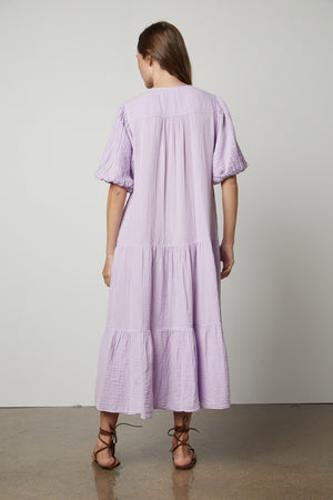 The back view of a woman wearing a Velvet by Graham & Spencer Pauline Cotton Gauze Midi Dress.