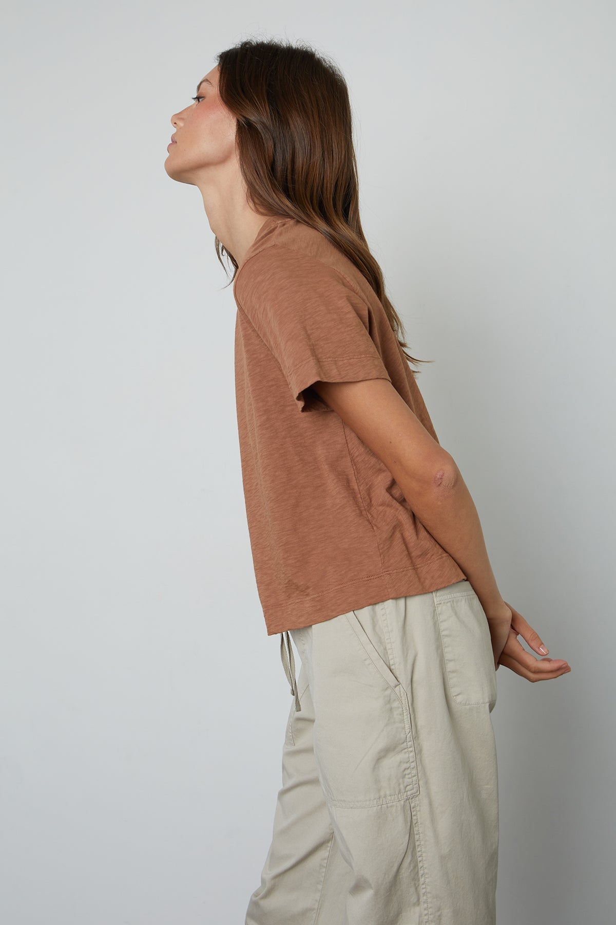 A vintage woman wearing a LULA COTTON SLUB SWING TEE by Velvet by Graham & Spencer and khaki pants.