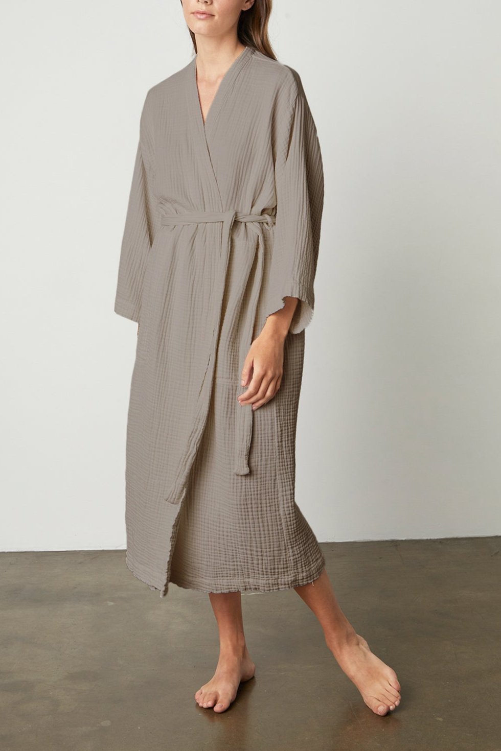 A woman wearing a Jenny Graham Home COTTON GAUZE ROBE standing in front of a white wall.-23554452422849