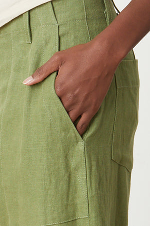 Dru Pant in basil green heavy linen close pocket detail with model's hand in pocket